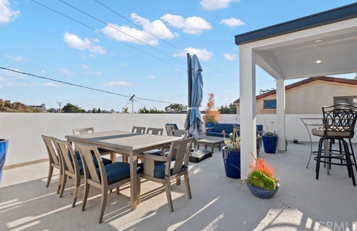 304 Iris Avenue Corona del Mar, CA 92625 - Photo 15 of 19 a dining area with furniture and city view
