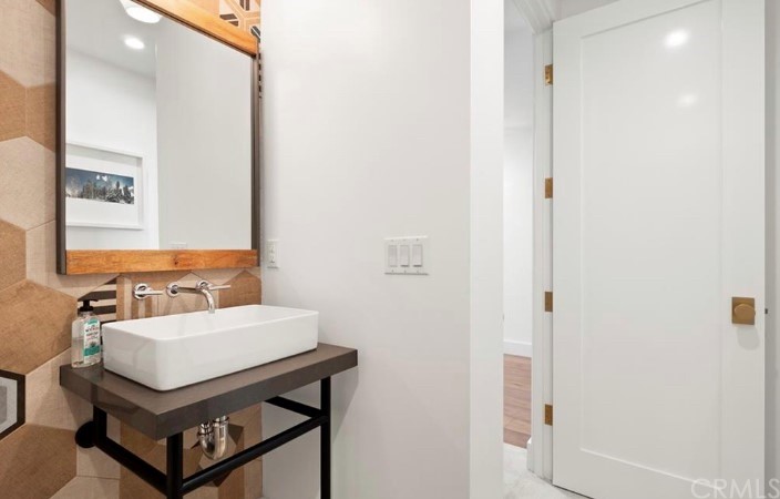 304 Iris Avenue Corona del Mar, CA 92625 - Photo 8 of 19 a bathroom with a sink a mirror and a toilet