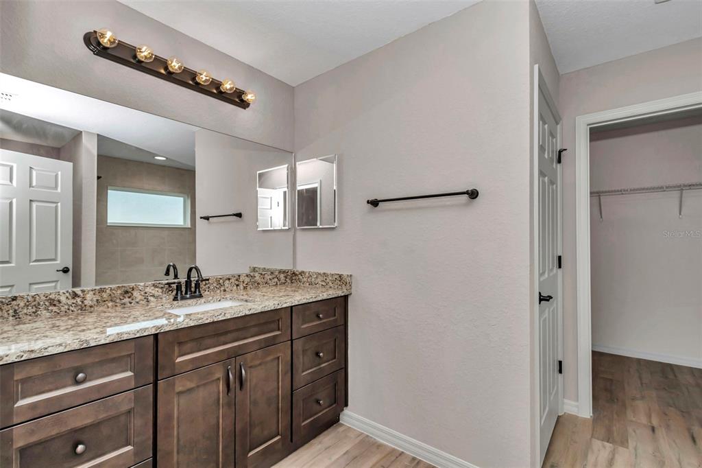 21 Pine Course Pass Ocala, FL 34472 - Photo 11 of 29 a bathroom with a double vanity sink and mirror