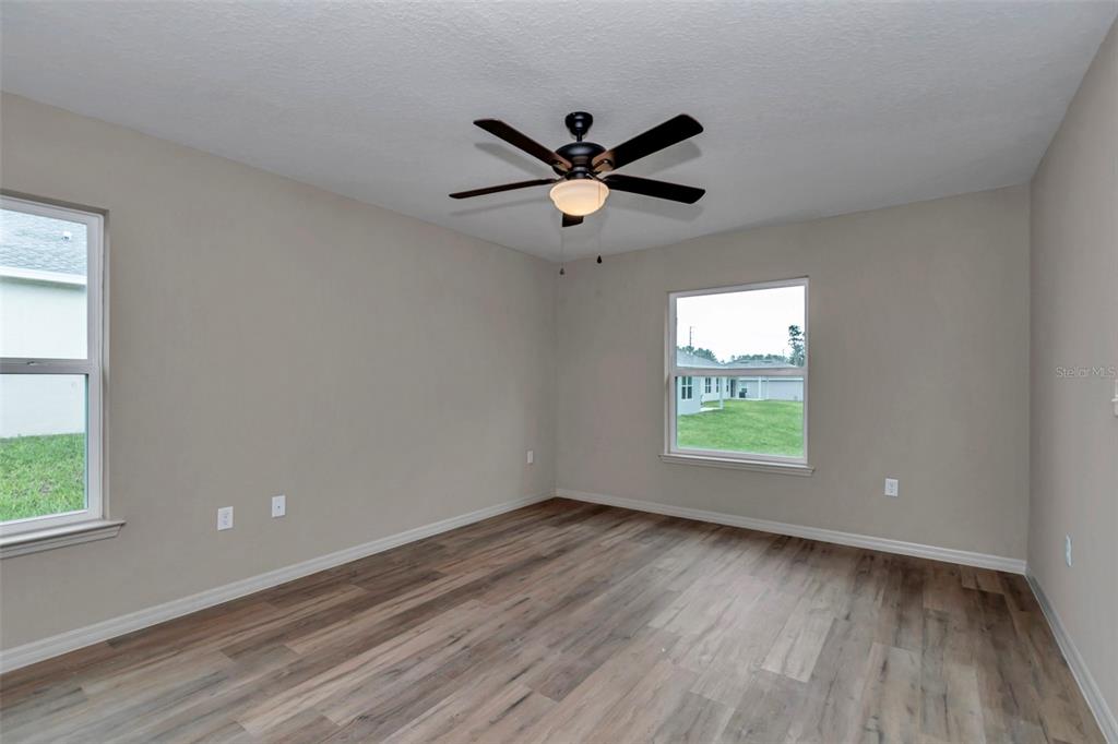21 Pine Course Pass Ocala, FL 34472 - Photo 12 of 29 a view of an empty room with wooden floor and a window