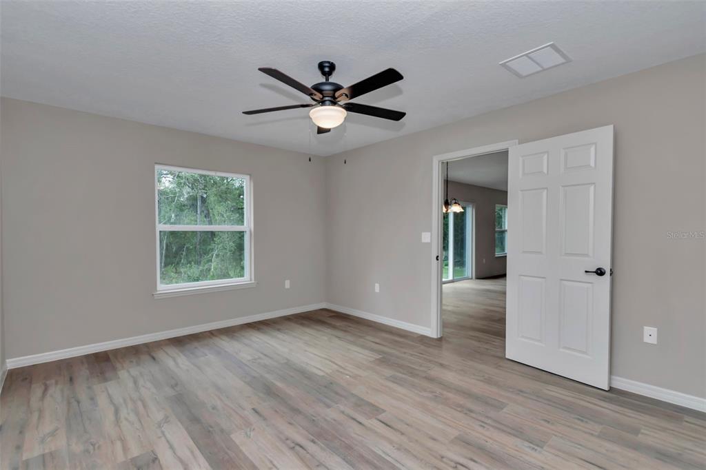 21 Pine Course Pass Ocala, FL 34472 - Photo 13 of 29 a view of an empty room with wooden floor and a window