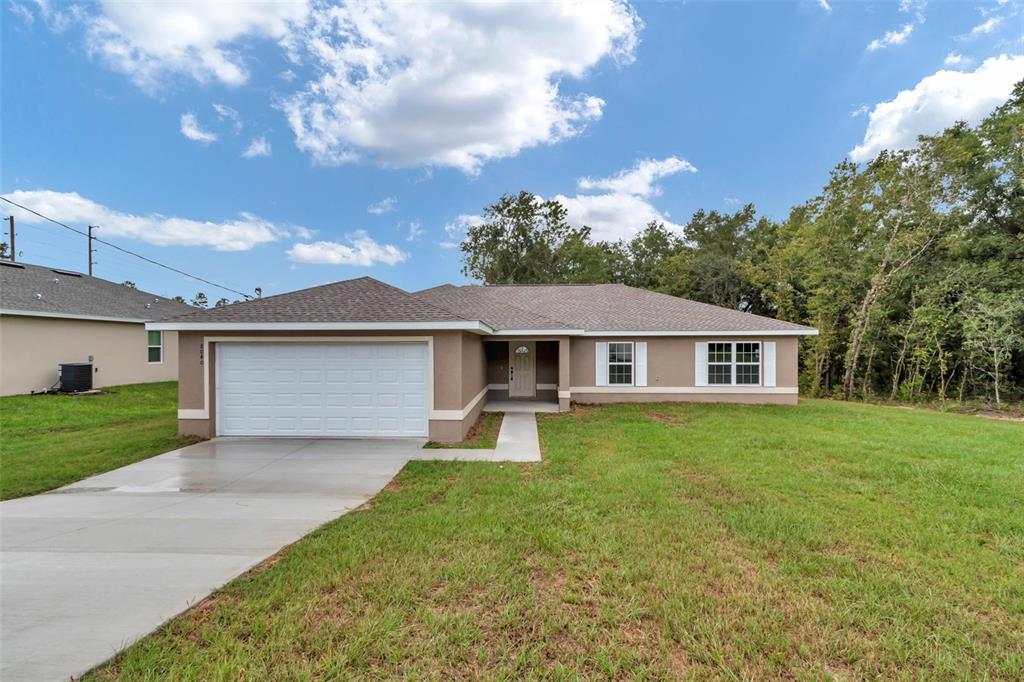 21 Pine Course Pass Ocala, FL 34472 - Photo 29 of 29 a front view of a house with garden