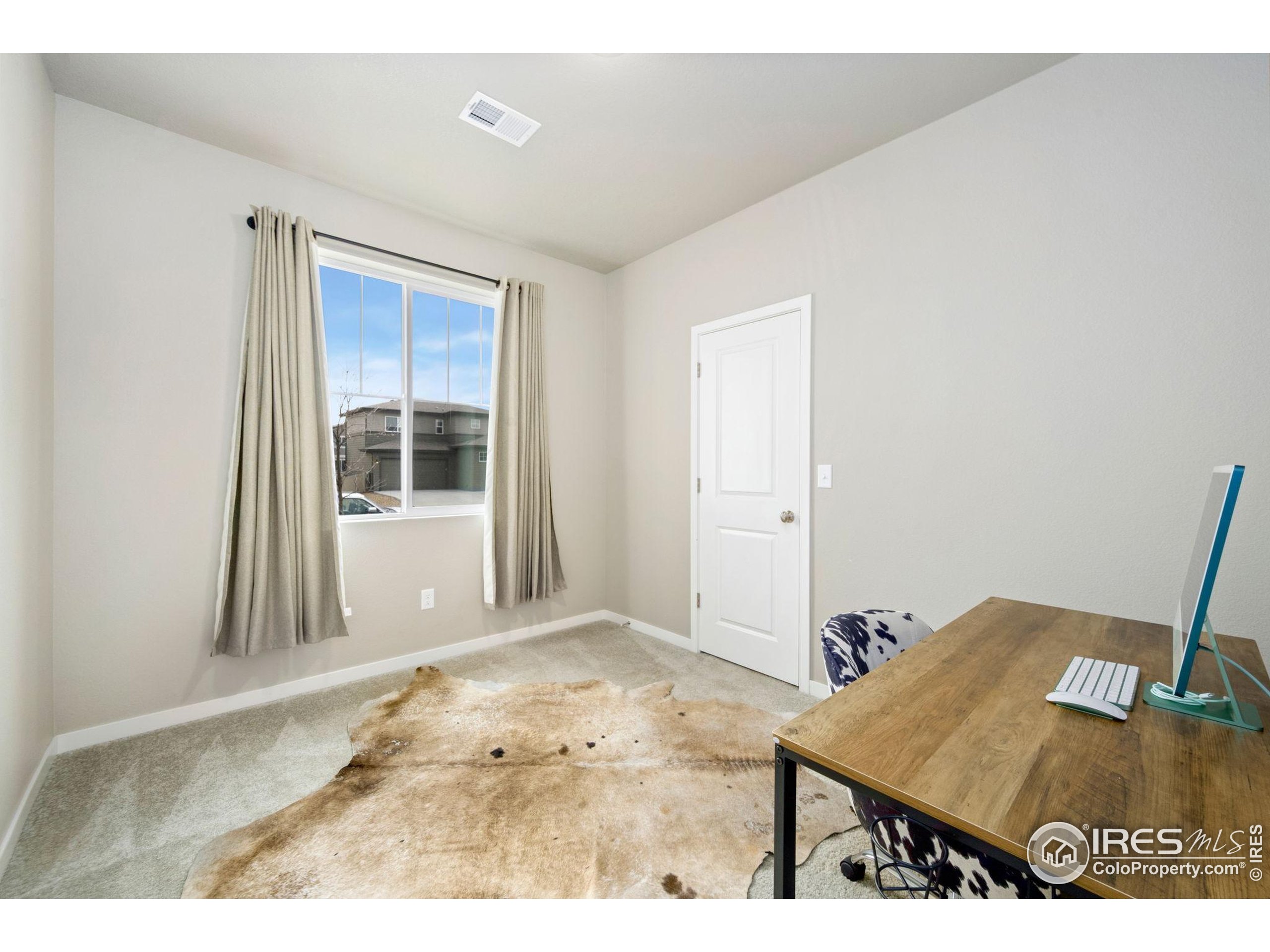 3812 Beech Tree Street Wellington, CO 80549 - Photo 12 of 17 hallway with wooden floor and windows