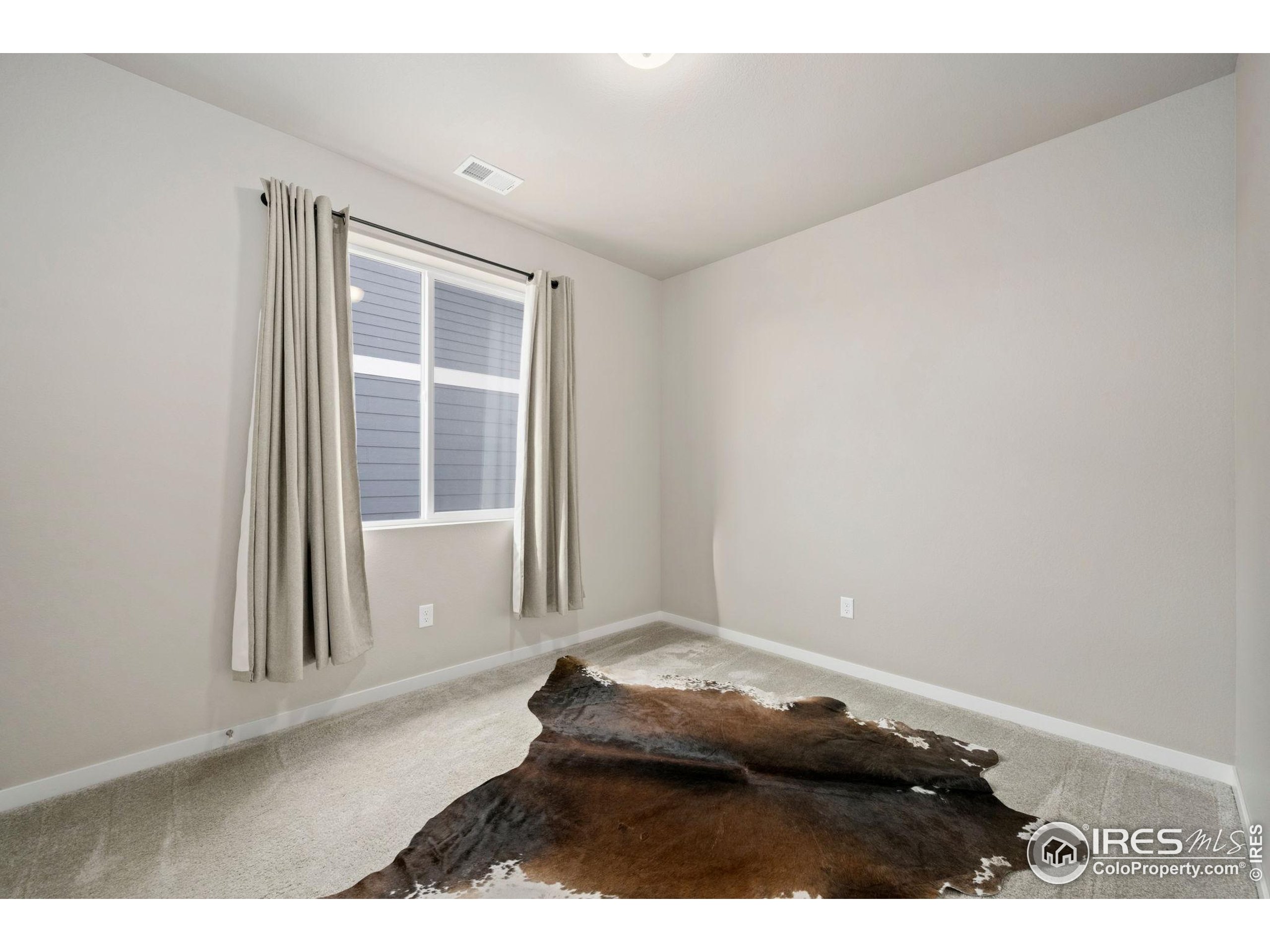 3812 Beech Tree Street Wellington, CO 80549 - Photo 13 of 17 view of an empty room with a window