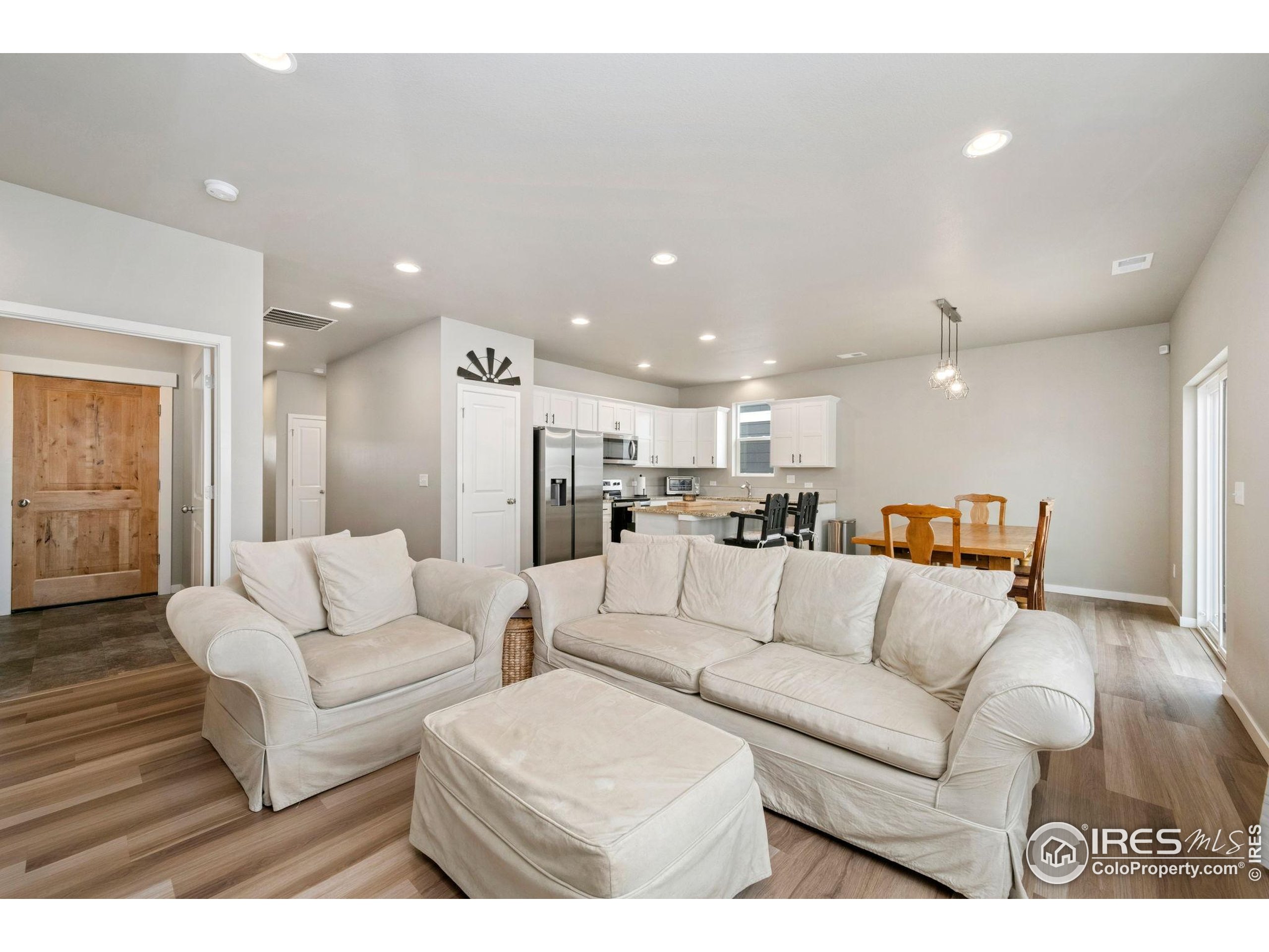 3812 Beech Tree Street Wellington, CO 80549 - Photo 4 of 17 a living room with furniture and a view of kitchen