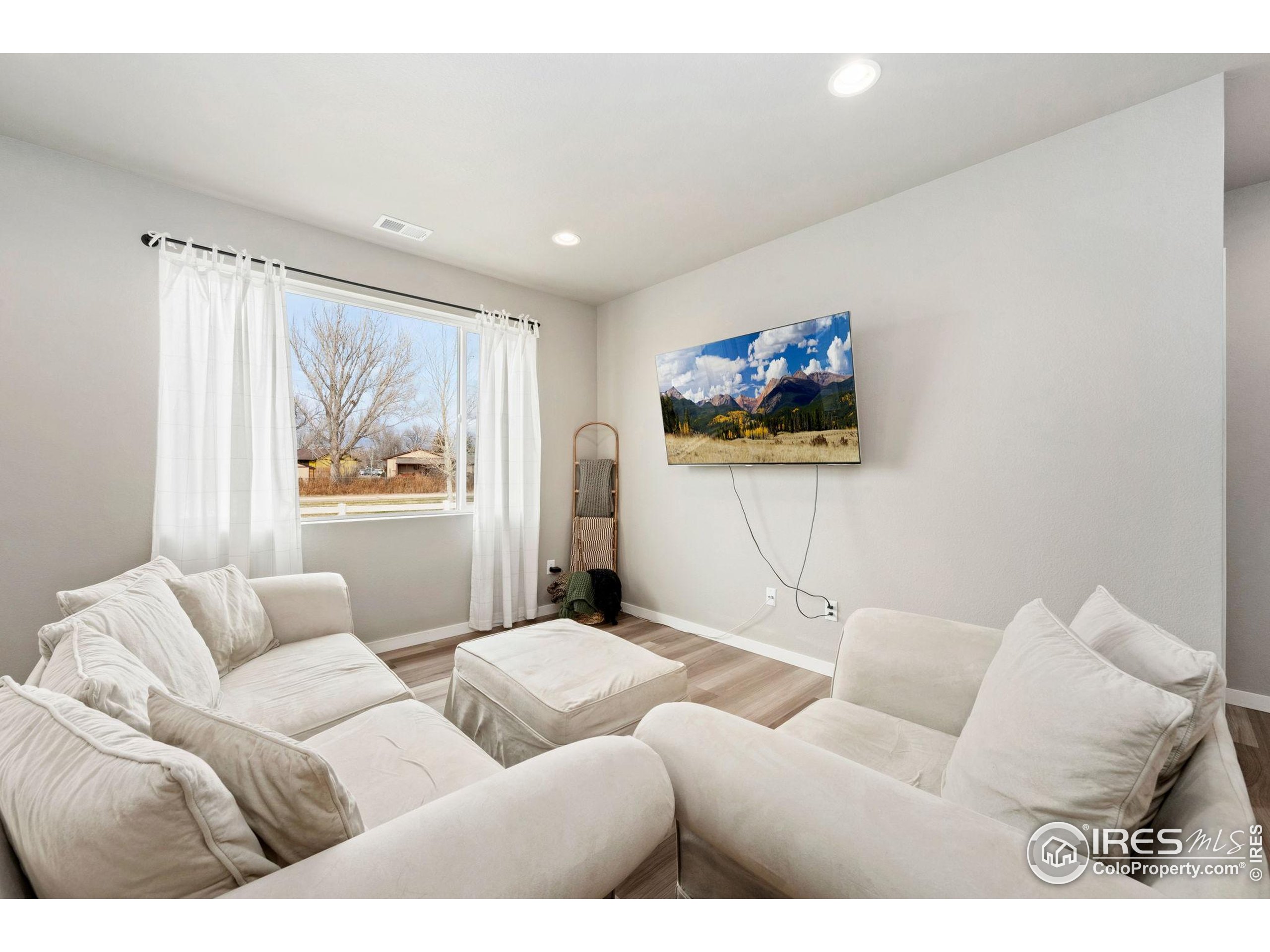 3812 Beech Tree Street Wellington, CO 80549 - Photo 5 of 17 a living room with furniture and a wall painting