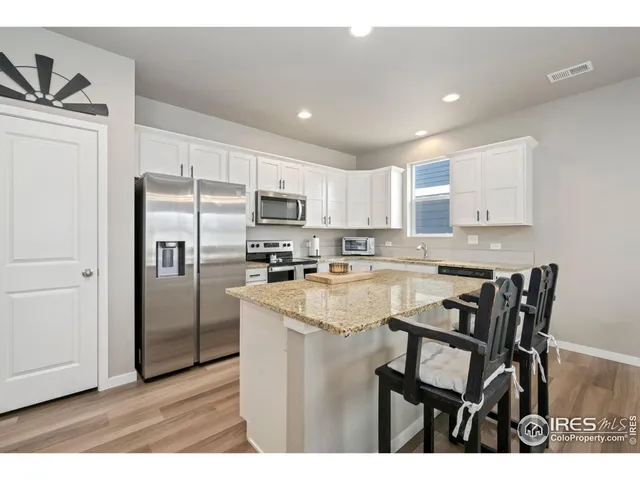 a kitchen with kitchen island a appliances cabinets a counter space and a sink