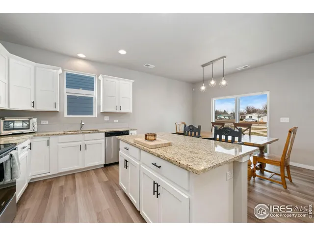 a kitchen with a stove a sink dishwasher and a refrigerator