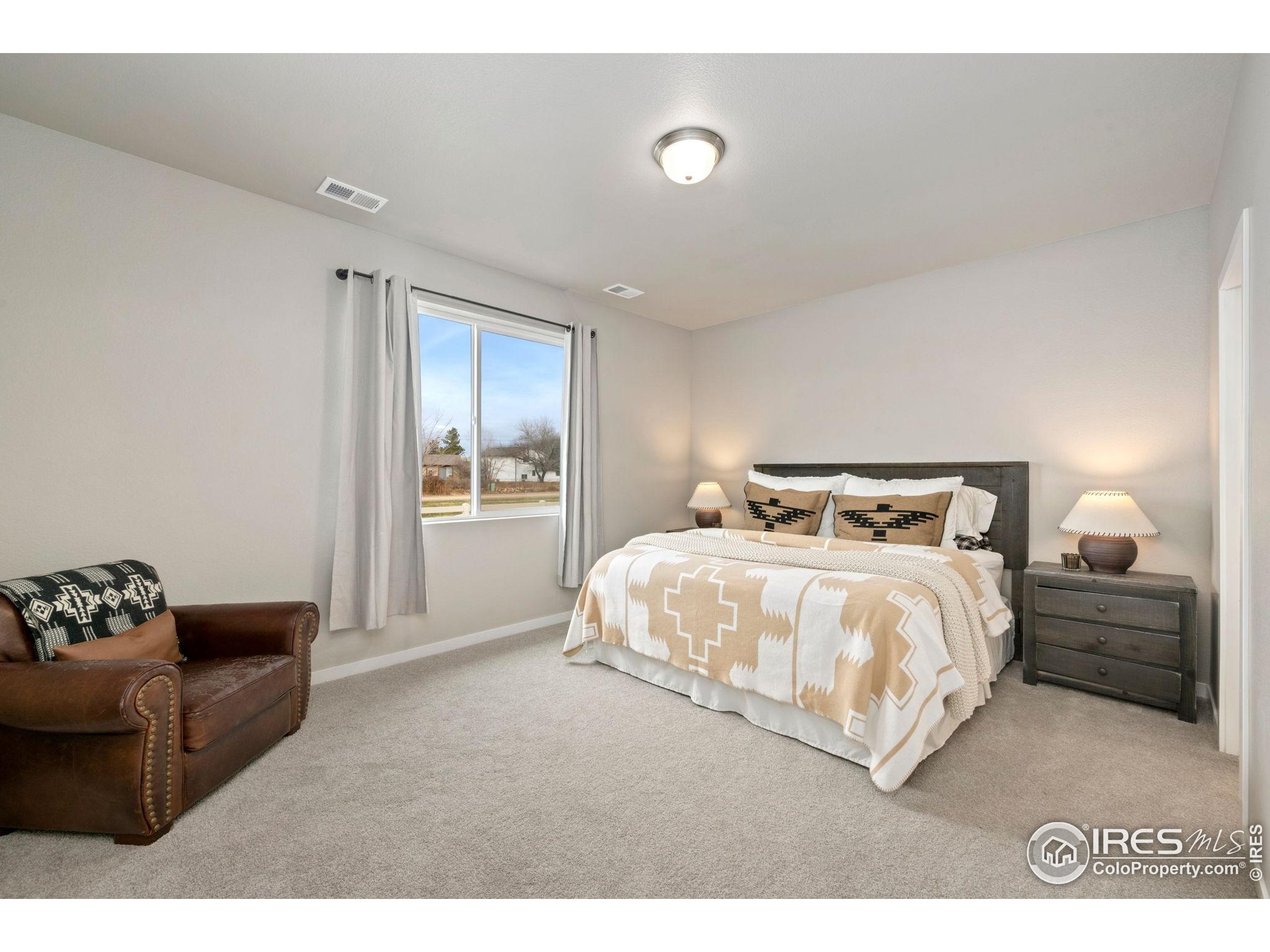 3812 Beech Tree Street Wellington, CO 80549 - Photo 10 of 17 a bedroom with a bed and a couch