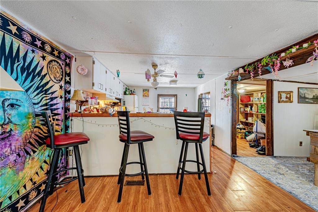 1249 Ridge Road Templeton, PA 16259 - Photo 13 of 37 a view of a dining room with furniture and wooden floor