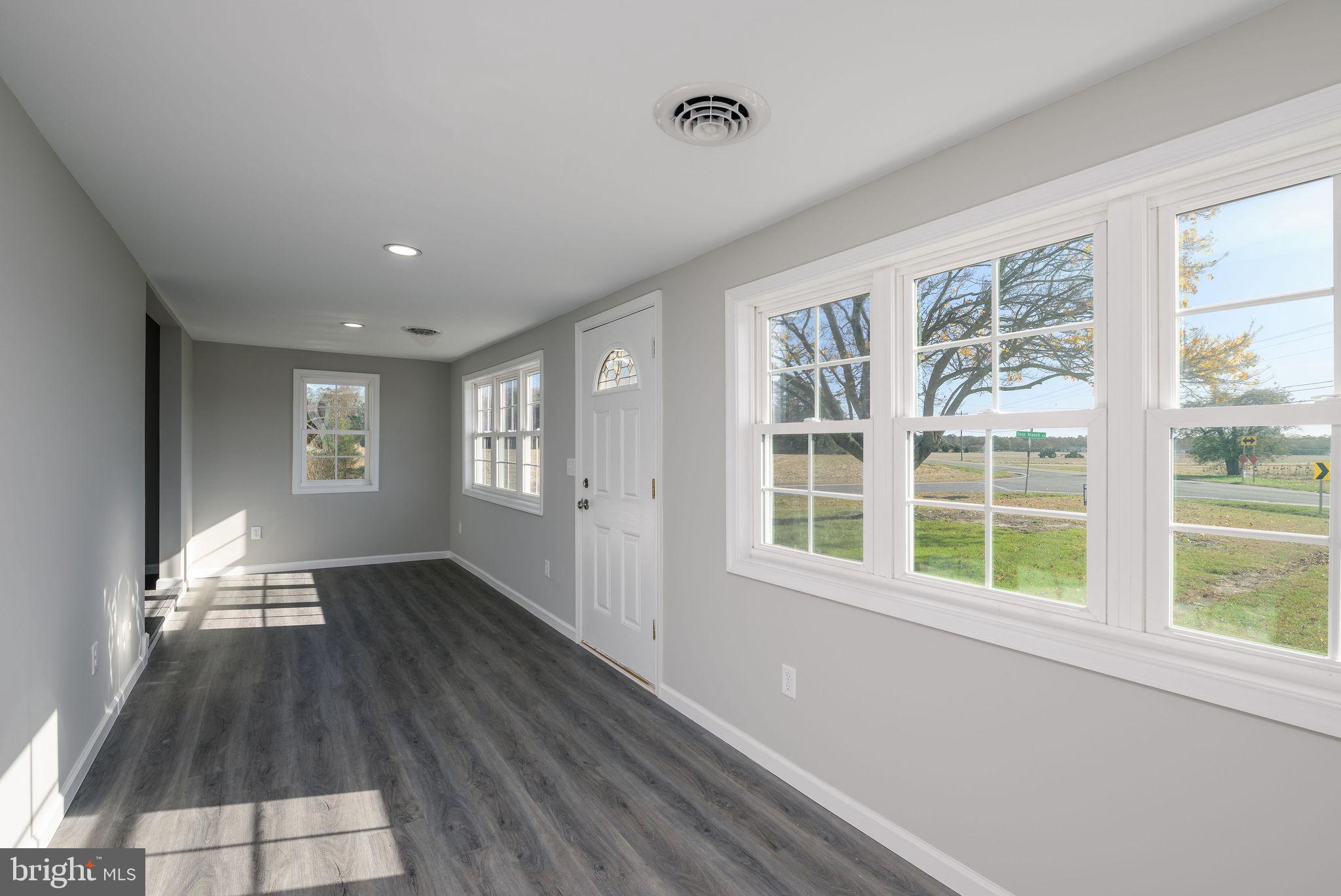24532 Deep Branch Road Georgetown, DE 19947 - Photo 20 of 43 a view of an empty room with wooden floor and a window