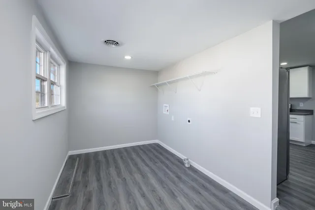 a view of room with window and wooden floor