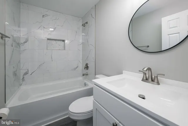 a bathroom with a sink a toilet and a mirror