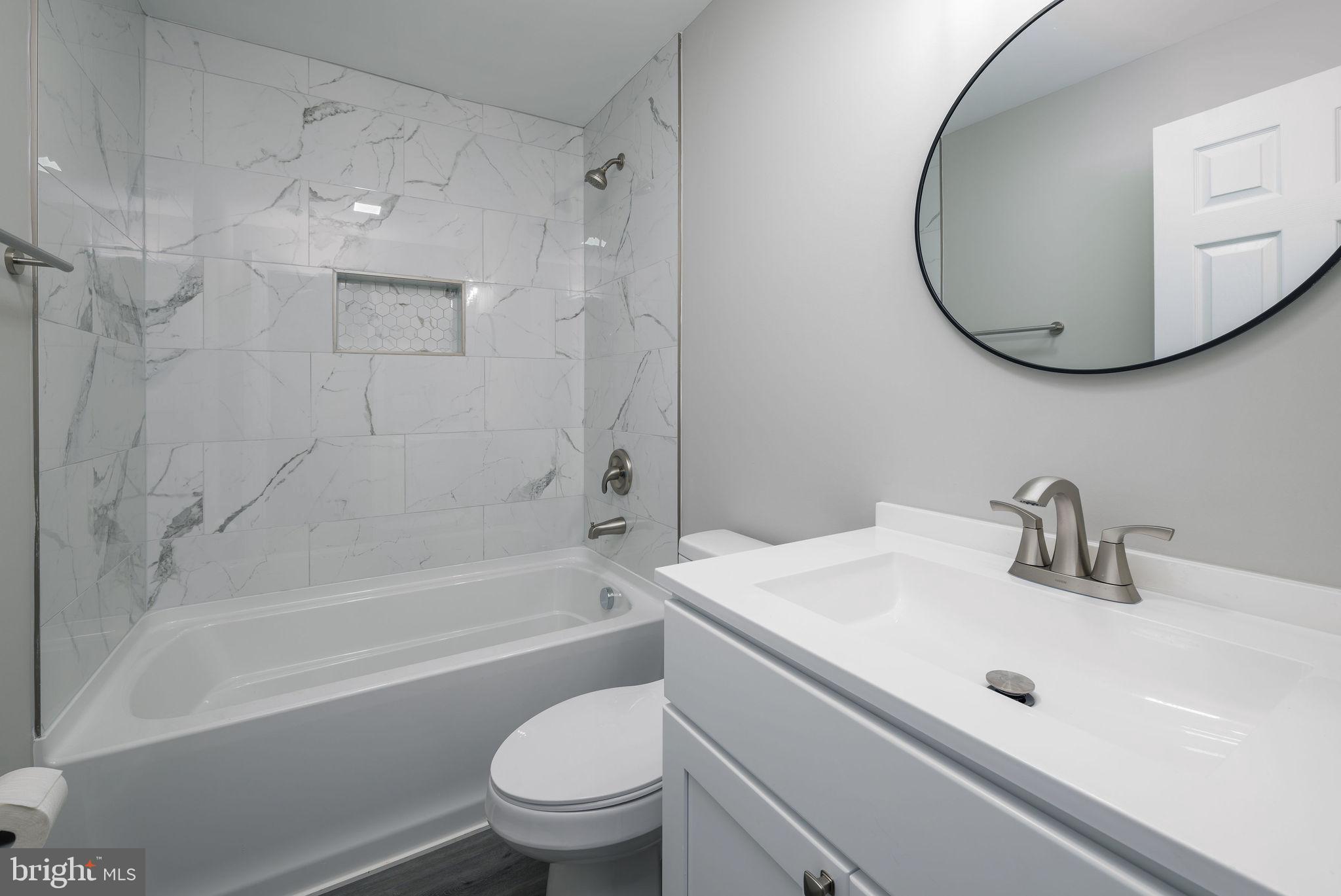 24532 Deep Branch Road Georgetown, DE 19947 - Photo 28 of 43 a bathroom with a sink a toilet and a mirror