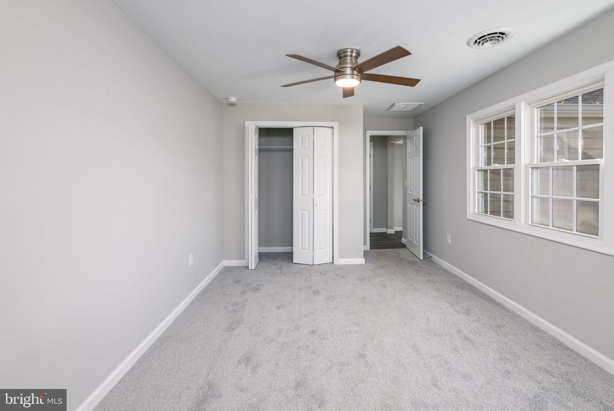 24532 Deep Branch Road Georgetown, DE 19947 - Photo 30 of 43 an empty room with windows and fan