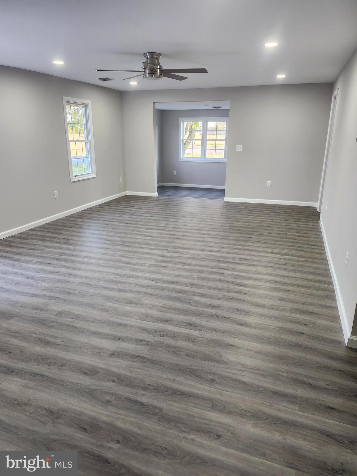 24532 Deep Branch Road Georgetown, DE 19947 - Photo 5 of 43 an empty room with wooden floor and windows