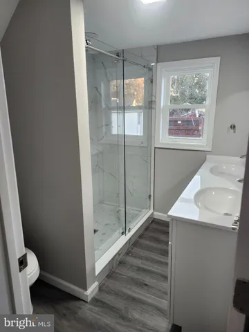 a bathroom with a toilet and a shower