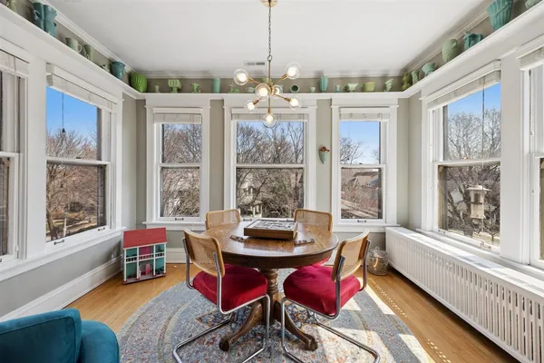 a dining room with furniture a chandelier and wooden floor