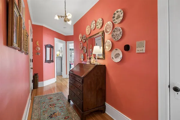 a dining room with furniture a chandelier and wooden floor