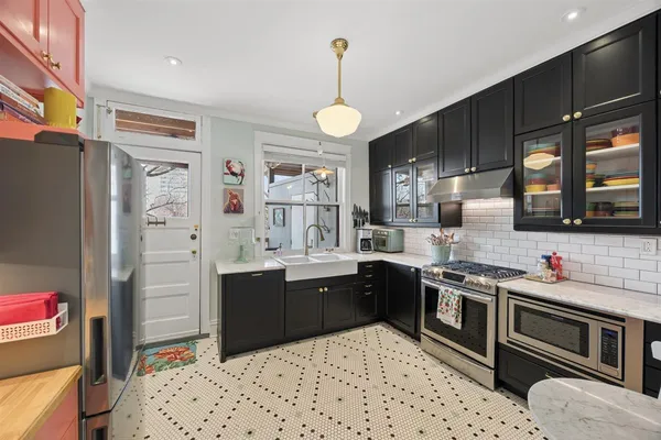 a kitchen with a sink stove and cabinets