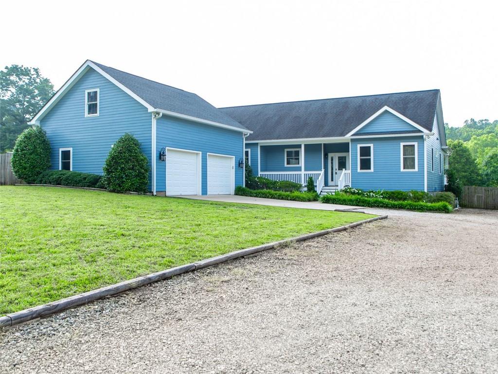 a front view of house with yard and green space