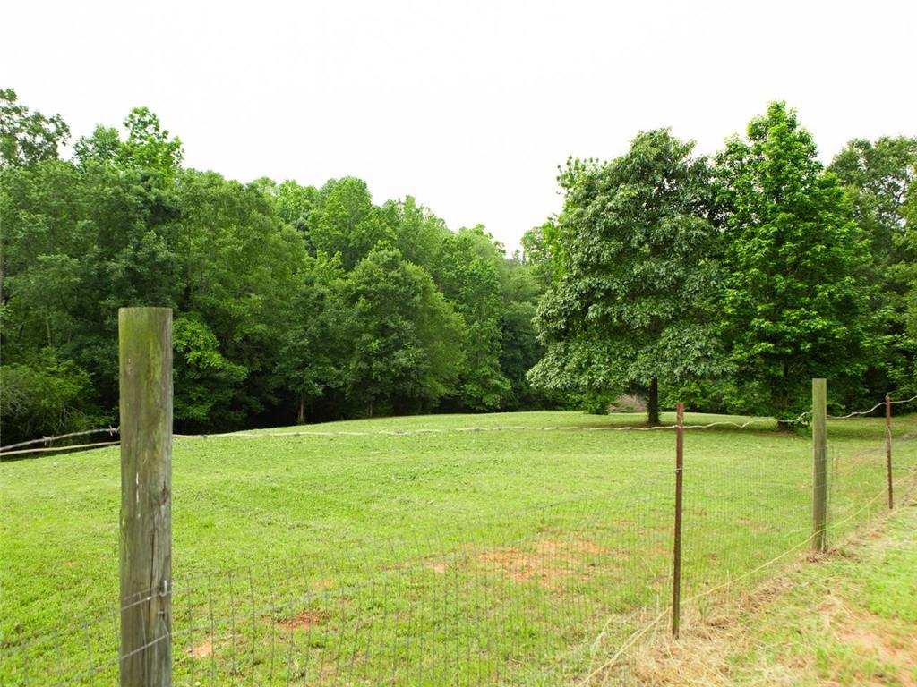 708 Sheep Pasture Road Commerce, GA 30529 - Photo 12 of 35 a view of a field with a tree