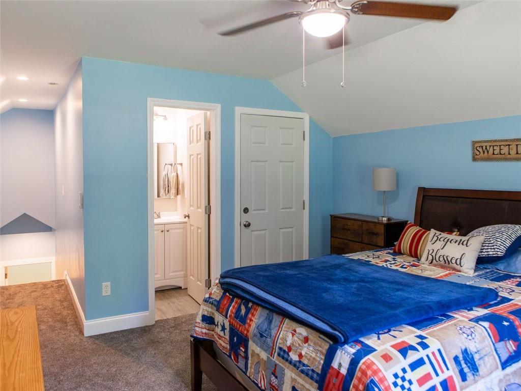 708 Sheep Pasture Road Commerce, GA 30529 - Photo 28 of 35 a bedroom with a bed and a chandelier