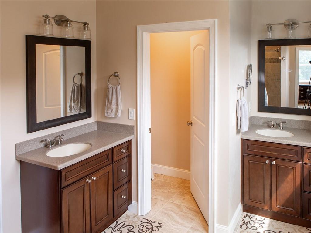 708 Sheep Pasture Road Commerce, GA 30529 - Photo 33 of 35 a bathroom with a sink a mirror and a vanity