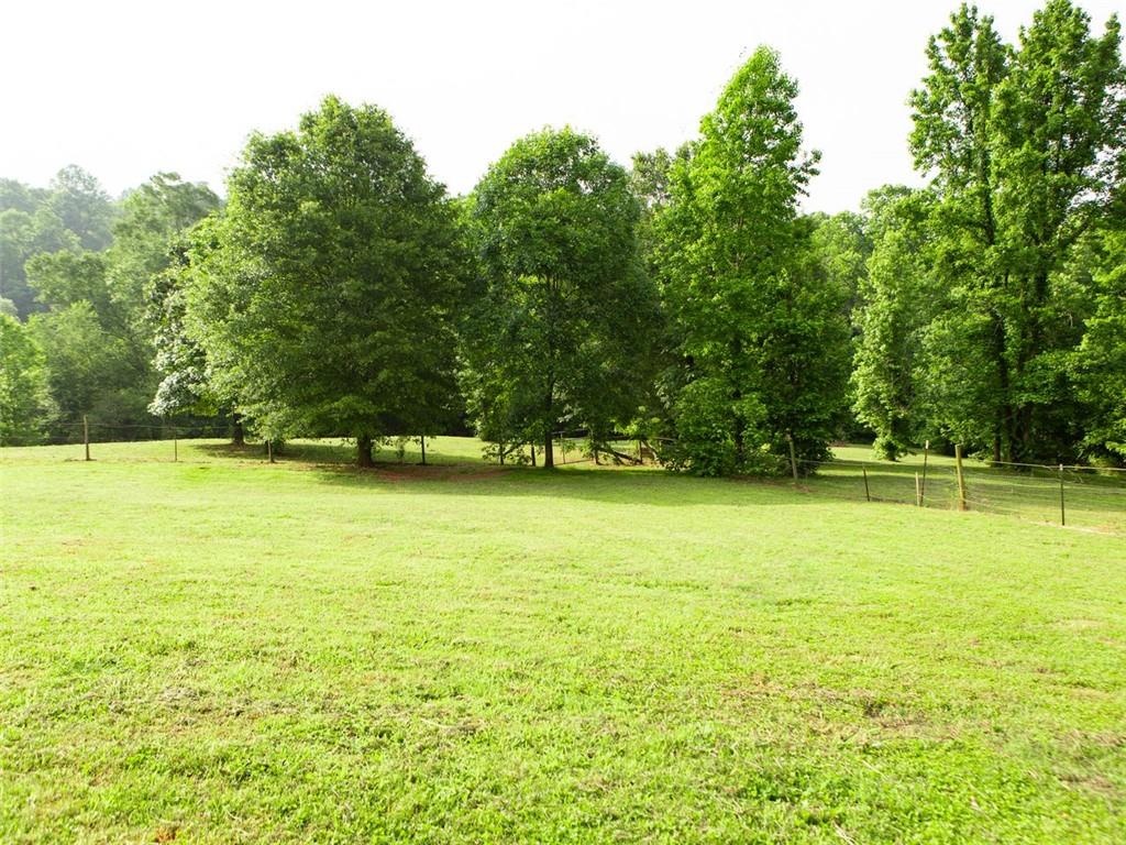 708 Sheep Pasture Road Commerce, GA 30529 - Photo 9 of 35 a view of swimming pool with an outdoor space and seating area