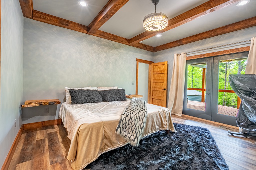 1220 Sunset Road Epworth, GA 30541 - Photo 17 of 46 a spacious bedroom with a bed and a large window