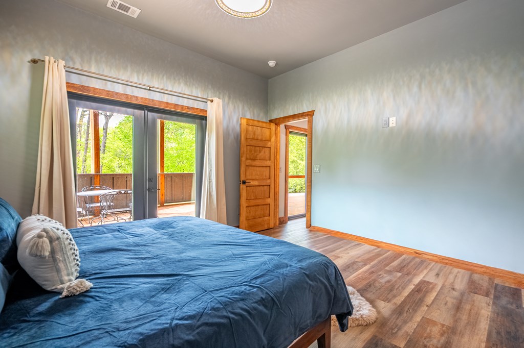 1220 Sunset Road Epworth, GA 30541 - Photo 31 of 46 a bedroom with a bed and wooden floor