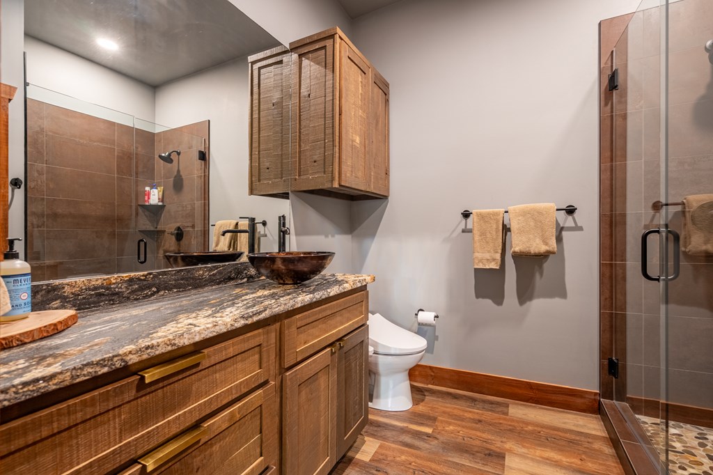 1220 Sunset Road Epworth, GA 30541 - Photo 32 of 46 a bathroom with a granite countertop sink toilet and shower