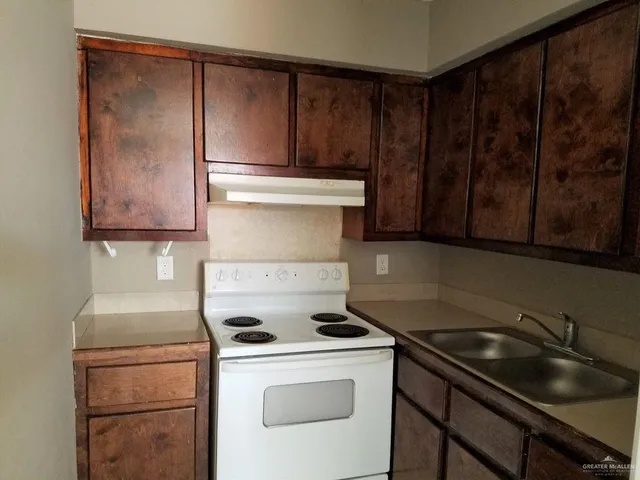 a kitchen with a stove and a sink