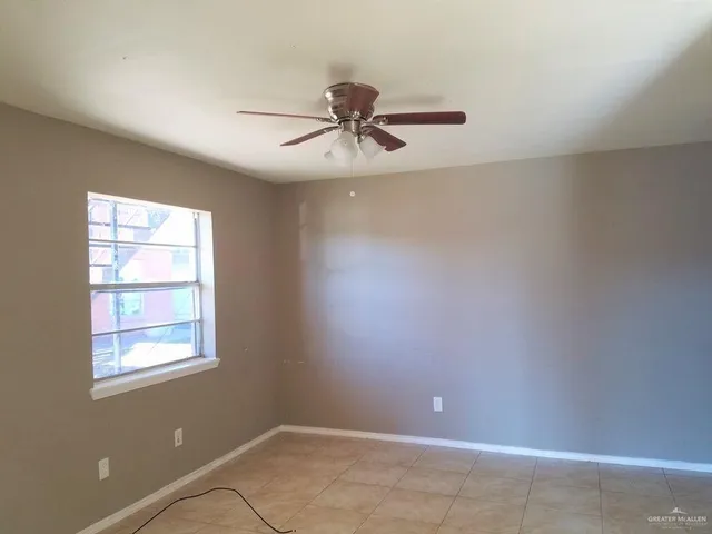 a view of a room with a window and a ceiling fan