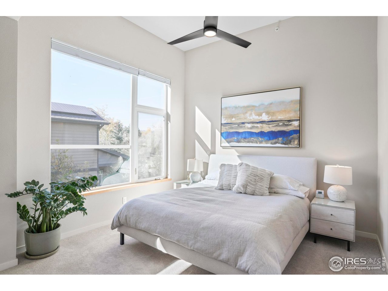 4190 Longview Lane Boulder, CO 80301 - Photo 17 of 29 a bedroom with a large bed and a painting on the wall