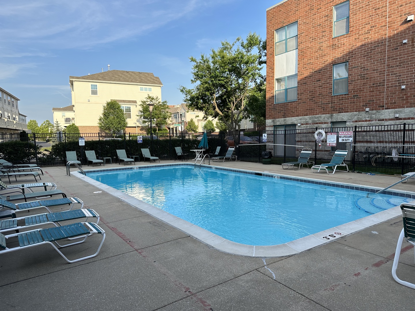 3265 Kirchoff Road, Unit 121 Rolling Meadows, IL 60008 - Photo 3 of 14 a view of a swimming pool with a lounge chair