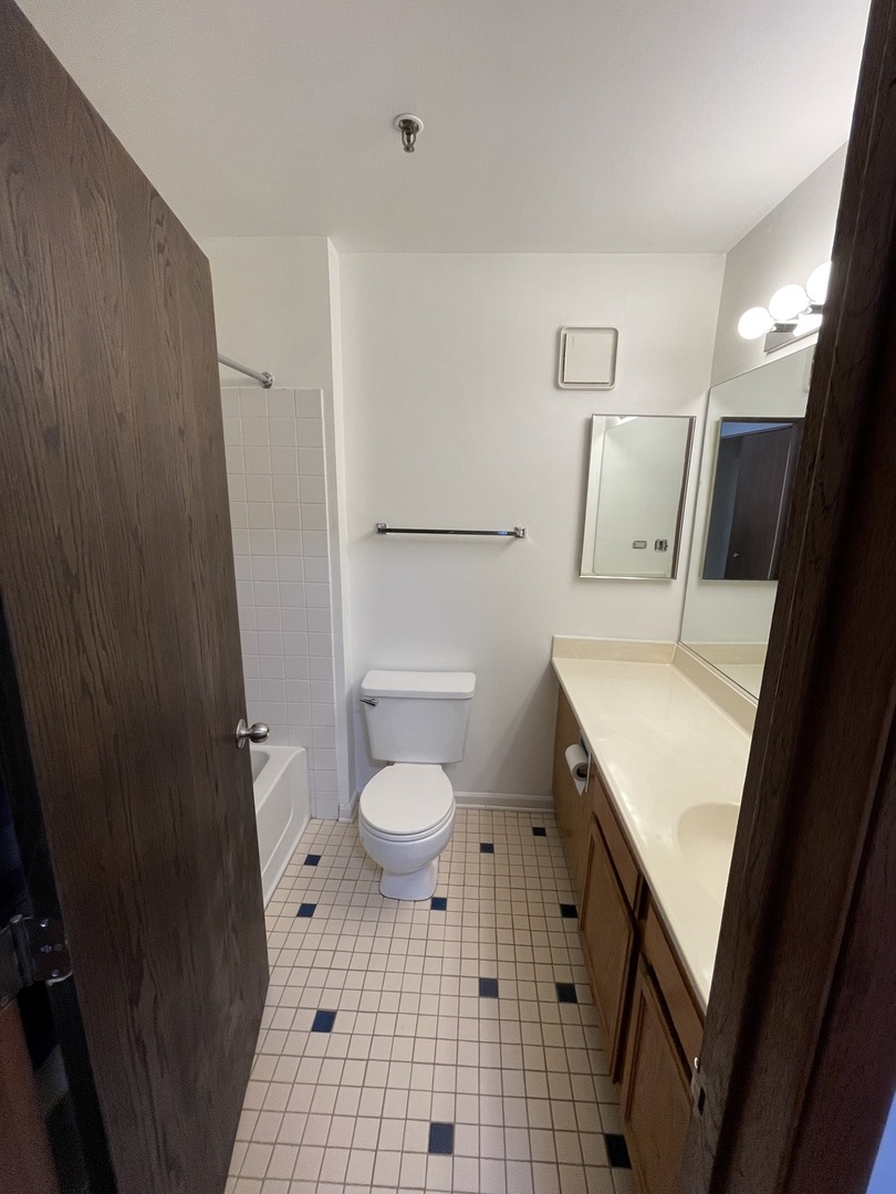 3265 Kirchoff Road, Unit 121 Rolling Meadows, IL 60008 - Photo 9 of 14 a bathroom with a sink a toilet a shower and a mirror
