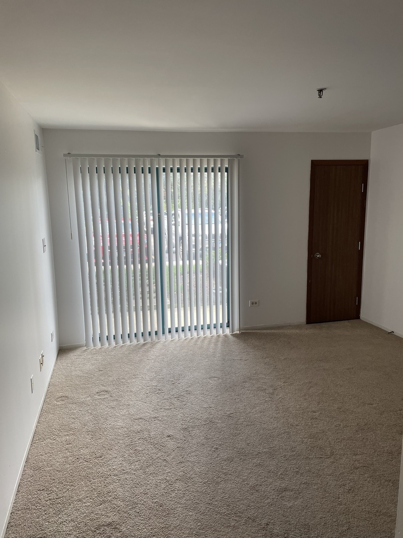 3265 Kirchoff Road, Unit 121 Rolling Meadows, IL 60008 - Photo 10 of 14 a view of an empty room with a window