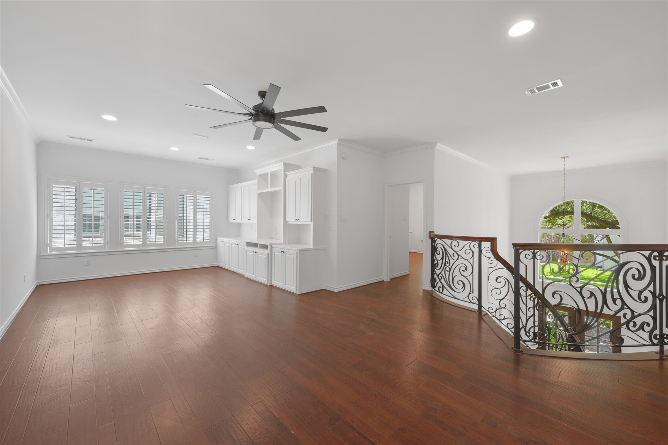 3724 Wroxton Road Houston, TX 77005 - Photo 20 of 40 Light and bright second floor landing/gameroom with ceiling fan, built-ins, hardwoods, and windows with Plantation-style shutters.