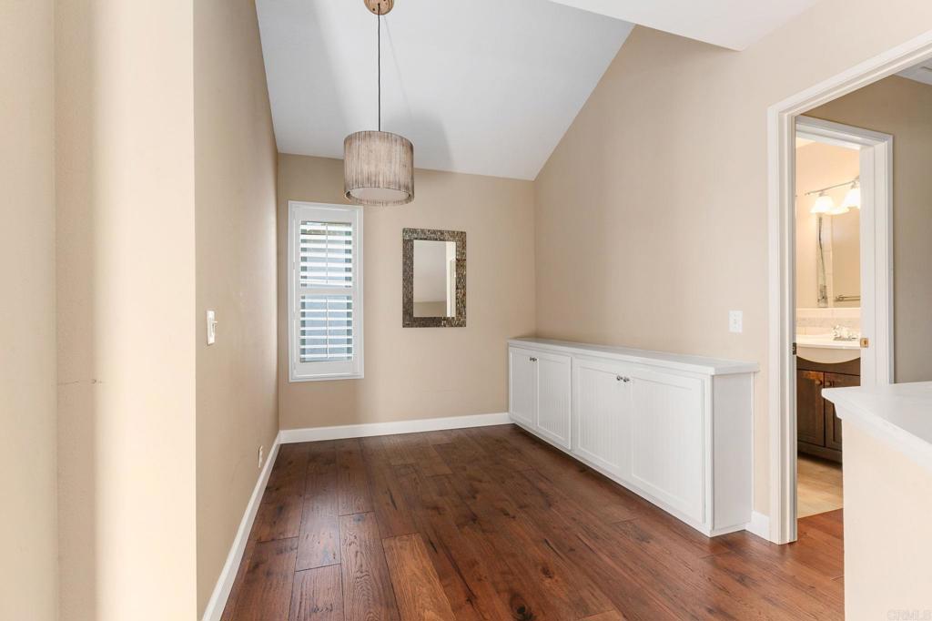1521 Flair Encinitas Drive Encinitas, CA 92024 - Photo 16 of 45 an empty room with wooden floor and windows