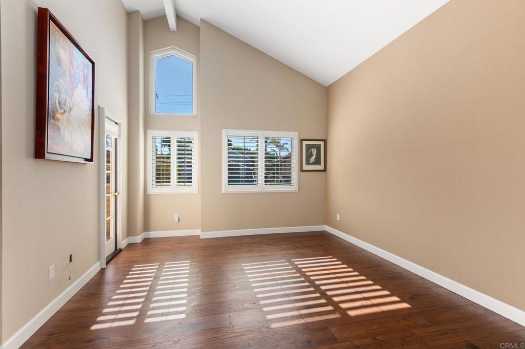 1521 Flair Encinitas Drive Encinitas, CA 92024 - Photo 17 of 45 a view of an empty room with wooden floor and a window