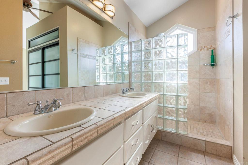1521 Flair Encinitas Drive Encinitas, CA 92024 - Photo 21 of 45 a bathroom with a sink and a mirror