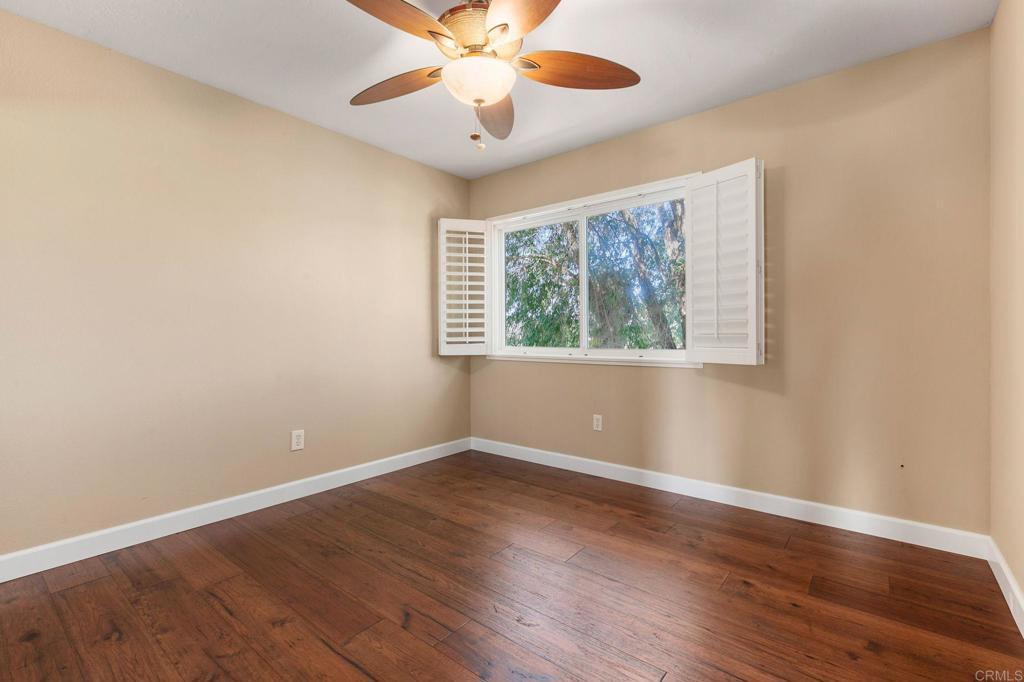 1521 Flair Encinitas Drive Encinitas, CA 92024 - Photo 23 of 45 a view of an empty room with wooden floor and a window