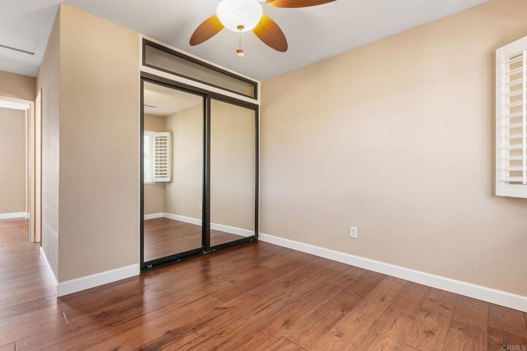1521 Flair Encinitas Drive Encinitas, CA 92024 - Photo 24 of 45 an empty room with wooden floor cabinet and windows