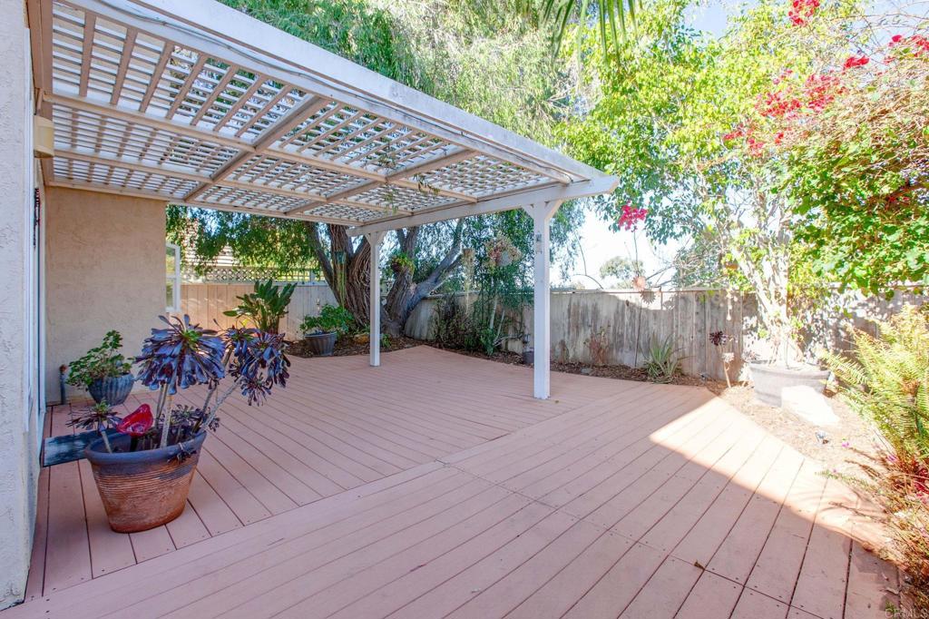 1521 Flair Encinitas Drive Encinitas, CA 92024 - Photo 29 of 45 a view of a patio with table and chairs potted plants with wooden floor and fence