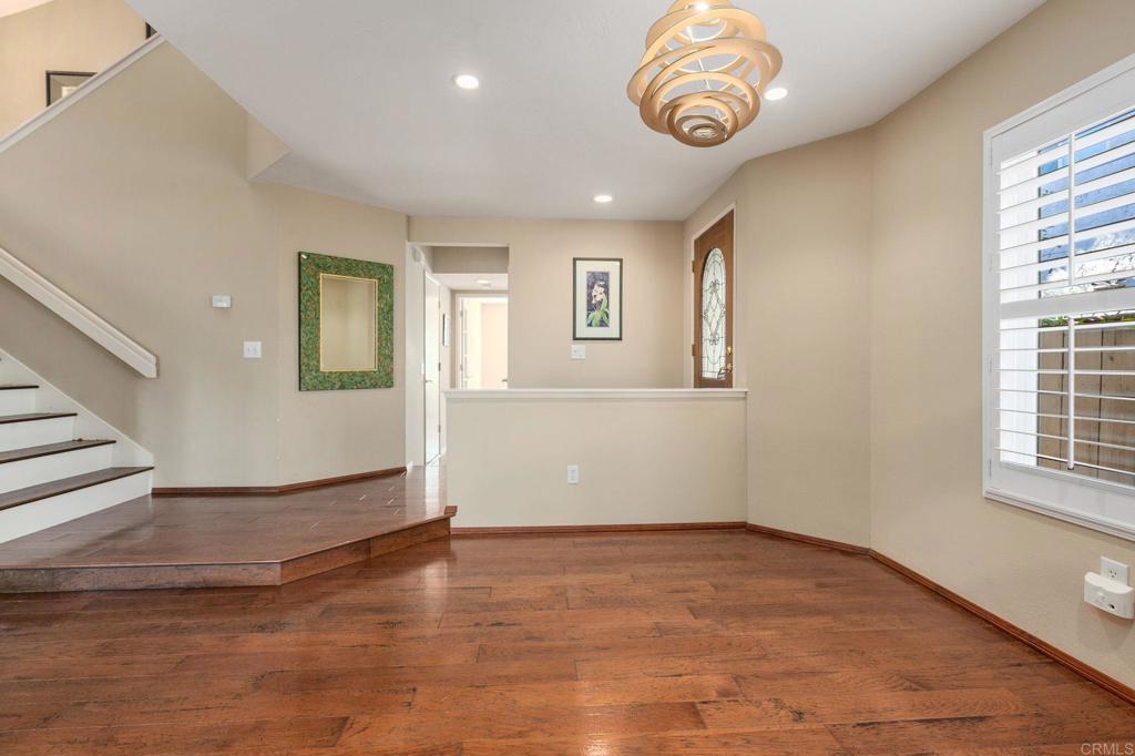 1521 Flair Encinitas Drive Encinitas, CA 92024 - Photo 8 of 45 an empty room with wooden floor and windows