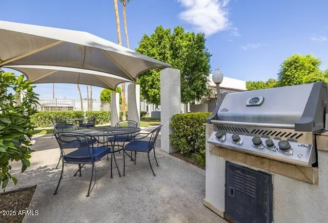 a view of an outdoor sitting area with a table and chair