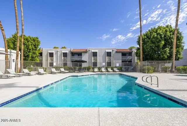 a swimming pool with outdoor seating and yard