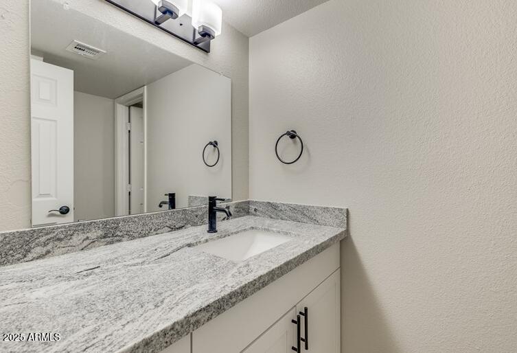 6505 East Osborn Road, Unit OFC Scottsdale, AZ 85251 - Photo 5 of 11 a bathroom with a granite countertop sink and a mirror