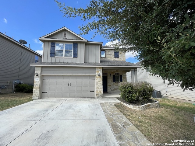 12310 Coal Mine Rise San Antonio, TX 78245 - Photo 1 of 19 a front view of a house with a garden and trees